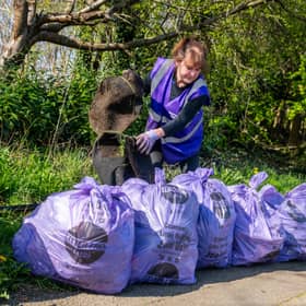  Sandra McLean, coordinator of Litter Free Leeds, with a collection of purple bags filled with rubbish collected on wasteland in Meanwood.