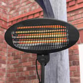 Harrier 2000W outdoor patio heater glowing orange, mounted on a stand against a brick wall
