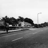 Looking south-west along Whitehall Road. Whitehall Tyres is on the left, then a row of shops which comprises of Chinese Food takeaway, Carparts, P.P.B. Racing Ltd. and The Apple Tree newsagents and off-licence. On the right is the Malt Shovel public house. Pictured in August 1981.