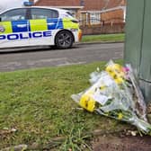 Flowers laid in Kennerleigh Avenue, Austhorpe, following the death of a 16-year-old girl