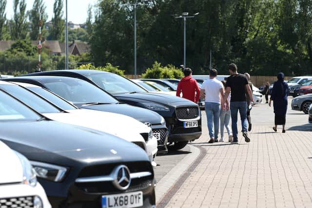 Customers at a car dealer. Compensation payouts are due on around 12.1 million unfair motor finance deals, at an average of £829 each, the financial watchdog has said as it unveiled the final plans for its redress scheme (Photo: Yui Mok/PA Wire)