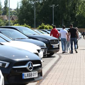 Customers at a car dealer. Compensation payouts are due on around 12.1 million unfair motor finance deals, at an average of £829 each, the financial watchdog has said as it unveiled the final plans for its redress scheme (Photo: Yui Mok/PA Wire)