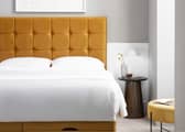 The Simba Hoxton bed in mustard velvet features a bold padded headboard and contemporary design finish