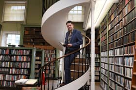 Ian Harker stands on a fully functional spiral staircase that dates right back to the 1800s.
