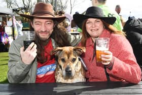 Nick and Louise Thatcher and Olga the dog enjoy a drink at the festival