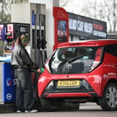 A customer fills up her car at a petrol service station in West Yorkshire. Petrol prices are rising as global tensions push up oil costs (Photo: Oli SCARFF / AFP via Getty Images)