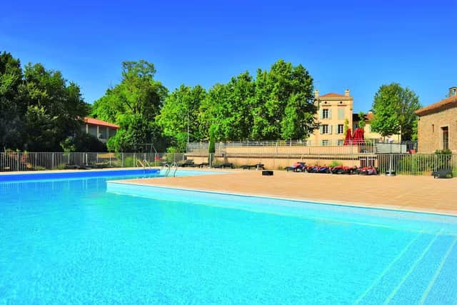 There is a heated outdoor pool bathed in sunshine