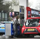 A customer fills up her car at a petrol service station in West Yorkshire. Petrol prices have surged, with a typical fill-up up by £14 (Photo: Oli SCARFF / AFP via Getty Images)