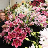 Gemma Miller amongst the lilies by Harts Nursery , who won a Premier Gold Award in the Grand Floral Hall.