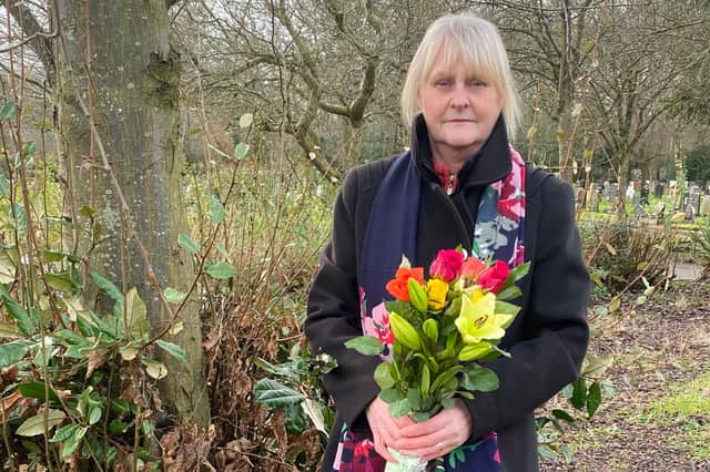 Christine Weatherhead beside the tree and plaque she placed in her sister Patricia Hall's memory