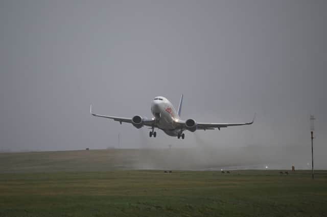 A passenger jet takes off from Leeds Bradford Airport  on 21 December 2023.