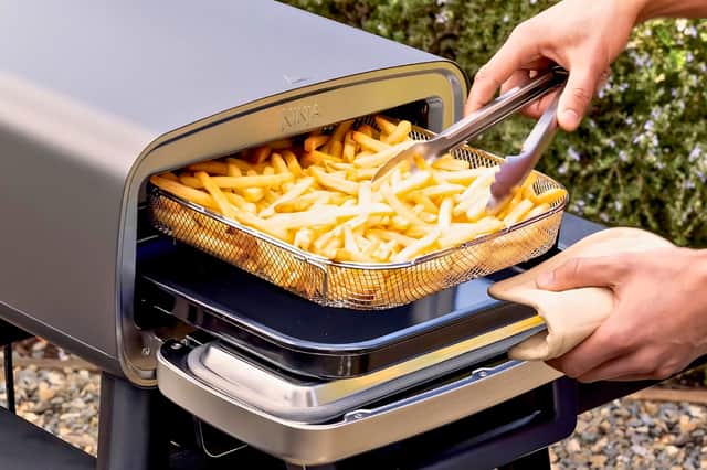 The Ninja pizza oven doubles as an air fryer, cooking chips and sides alongside pizzas