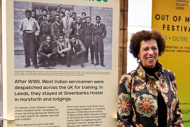 Barbara Goodison alongside a 2023 For, King Country & Home exhibition panel featuring her late father, Jamaican-born Astley 'Tommy' Thomas (1928-1960) .