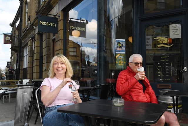 Angela Cossgrove, bar manager of Prospect, is joined by a punter for a drink in the sun.