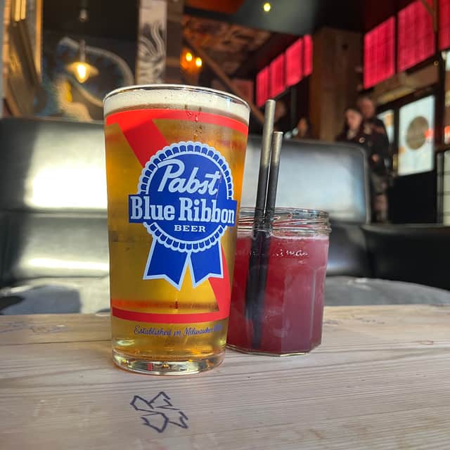 One of the cocktail specials, a twist on a margarita featuring blueberry jam, and pint of Pabst Blue Ribbon