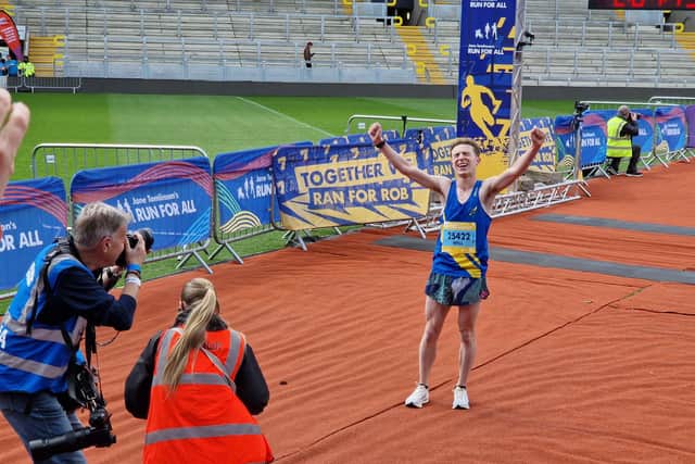 The half marathon winner Will Tighe crosses the finish line at Headingley Stadium
