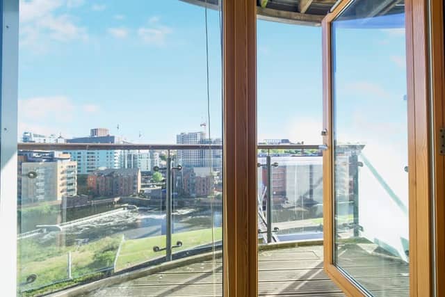 Floor-to-ceiling windows help frame the impressive riverside setting from the living space