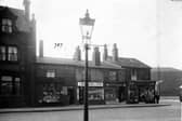 Bensons Place, a cobbled street off Belle Isle Road, pictured in  December 1935. The Bay Horse Hotel, Wilfred Gavins greengrocers, J. Bradbury and Sons pork butchers, Arthur Place boot and shoe maker, Arthur James Hawkes draper and the Cooperative Wholesale Society Brush factory are shown.