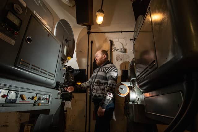 Projection Manager Mike Sharples checking the 35mm projectors.