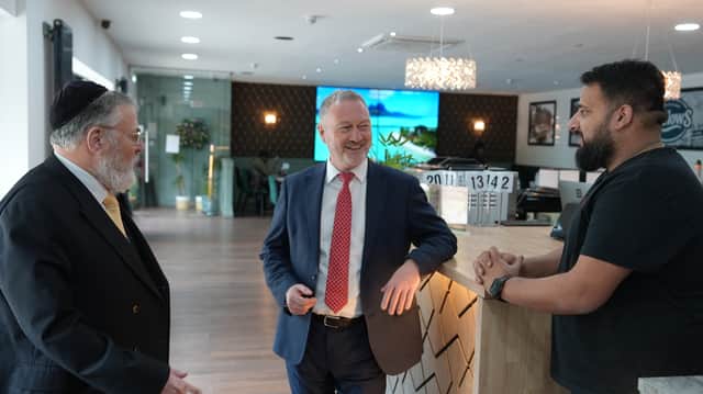 Marlow’s British Kitchen, in Moortown, a Muslim-owned fish and chip shop, is now offering kosher meals. This came about after a conversation between co-owner Arabaab Munir (right) and local Rabbi Anthony Gilbert (left), pictured with Communities Secretary Steve Reed. Credit: MHCLG