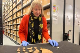 Kat Baxter, Leeds Museums and Galleries’ curator of archaeology, with ancient artefacts discovered inside a Bronze Age burial mound in Leeds.