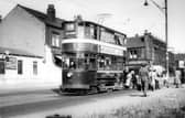 Passengers alighting from tram no.114 at a stop on Stanningley Road. The Station Garage is on the left. To the right of the tram is Bramley Home Bakeries at the junction with Hough Lane. Pictured in August 1952.