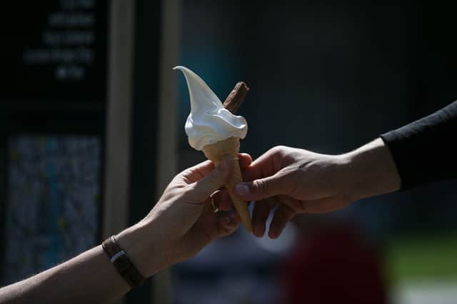 A man buys an ice cream in the hot and sunny weather in London on 26 May 2017.