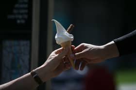 A man buys an ice cream in the hot and sunny weather in London on 26 May 2017.