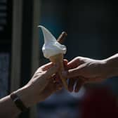 A man buys an ice cream in the hot and sunny weather in London on 26 May 2017.