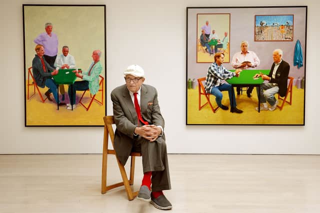 David Hockney sitting in front of his work entitled Card Players (left) and A Bigger Card Players at the launch of an Exhibition of his work called David Hockney: Painting And Photography at Annely Juda Fine Art in central London