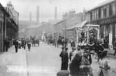 Hunslet Carnival looking north along Hunslet Road. People are on the roads and pavements watching a procession of horse and carts go past. Pictured in June 1906.