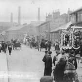 Hunslet Carnival looking north along Hunslet Road. People are on the roads and pavements watching a procession of horse and carts go past. Pictured in June 1906.