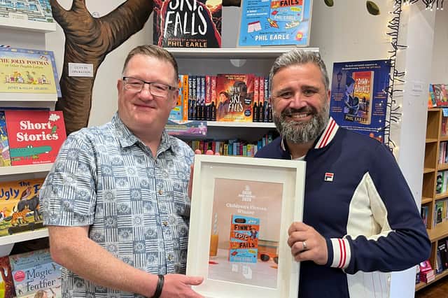 Phil Earle (right) of Hebden Bridge receiving his award after winning the Children's Fiction prize as part of the Indie Book Awards 2026.