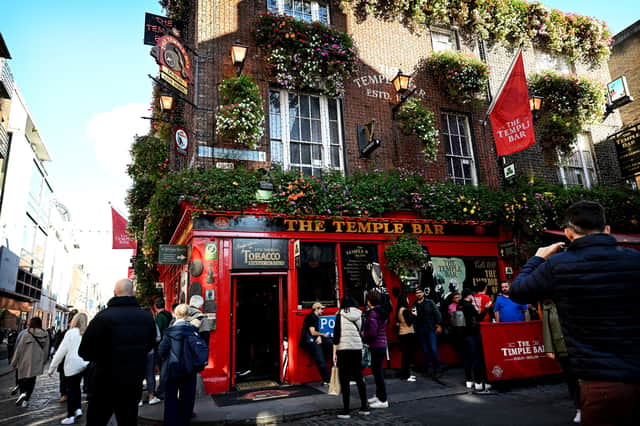 Drinkers and tourists visit the Temple Bar pub in the Temple Bar area of Dublin.