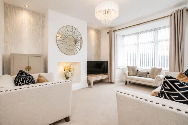 Natural light pours through the lounge’s bay window, enhancing the home’s welcoming and carefully maintained interior