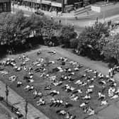 A photo taken from the tower of St. John's Church showing office workers taking in the sun during their lunch break in June 1981.