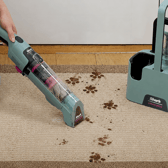 The cordless Shark StainForce comes with a storage caddy, two attachments and two 500ml bottles of cleaning solution