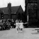 Taken in the playground of Sheepscar Council School, parents and carers have gathered to watch the pupils take part in May Day celebrations.