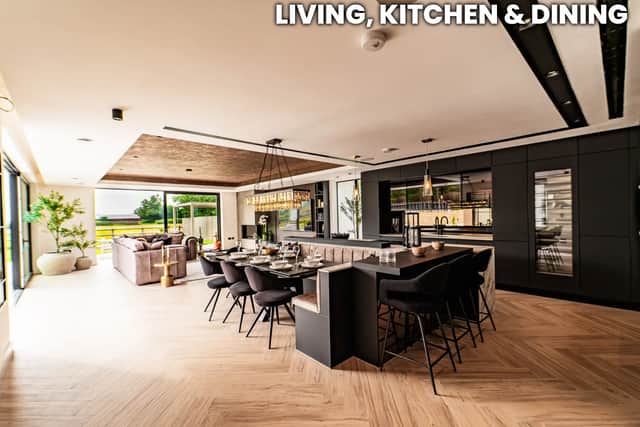 The open-plan kitchen and living space includes Gaggenau appliances, a Bora hob, Quooker tap, wine chiller and oversized island