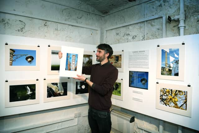 Assistant community curator Chris Sharp with photographs taken by members of the Camera-arderie Photography Group, on display at Leeds Industrial Museum.