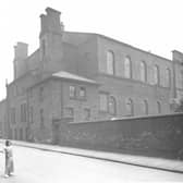 A young girl looks towards the camera outside Queen Street Congregational Chapel in August 1936.