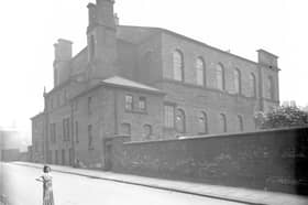 A young girl looks towards the camera outside Queen Street Congregational Chapel in August 1936.