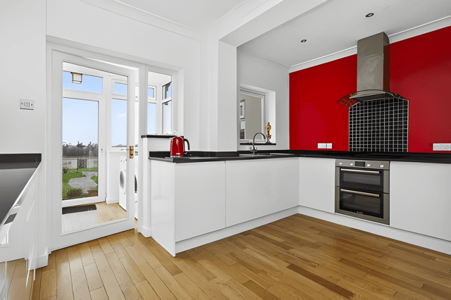 The well-planned kitchen enjoys garden views and connects seamlessly with the home's flexible living spaces.