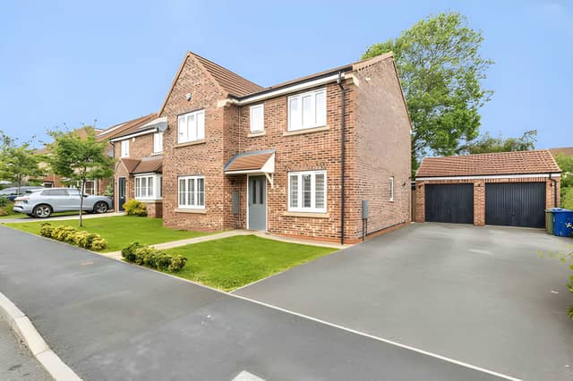 The detached home makes an impressive first impression with driveway parking and a practical family-friendly layout behind the front door.