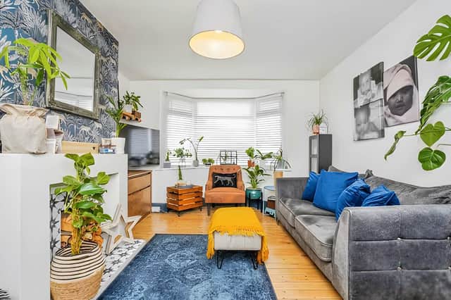 Natural light fills the front reception room, providing a comfortable space to relax throughout the day.