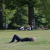 People enjoy the sunshine in Roundhay Park in Leeds.