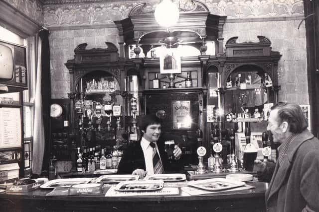 Lawrie Graham behind the bar at The Garden Gate pub in January 1977.
