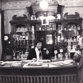 Lawrie Graham behind the bar at The Garden Gate pub in January 1977.
