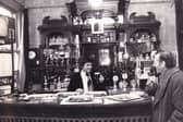 Lawrie Graham behind the bar at The Garden Gate pub in January 1977.