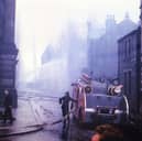 A fire engine and crew at work to extinguish the blaze which spread through the Town Hall in August 1961 after starting in Albert Mills behind.